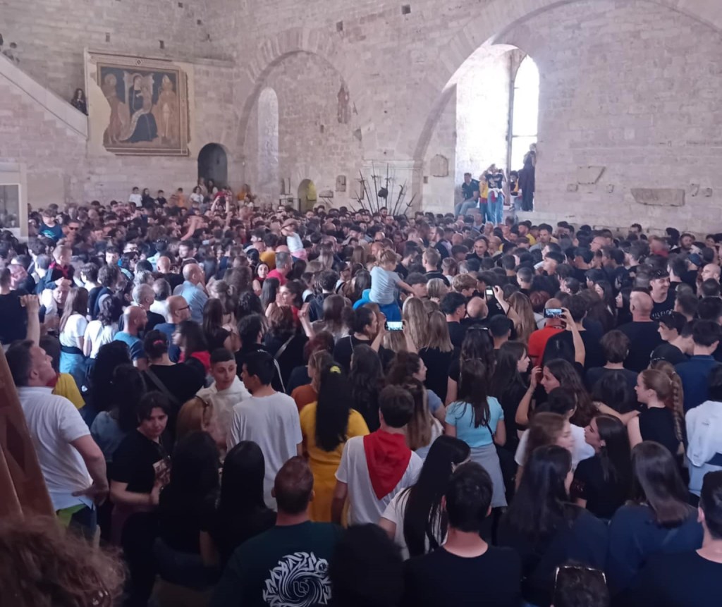 Un gruppo numeroso di persone riunite all'interno di un edificio, probabilmente durante un evento o una celebrazione.