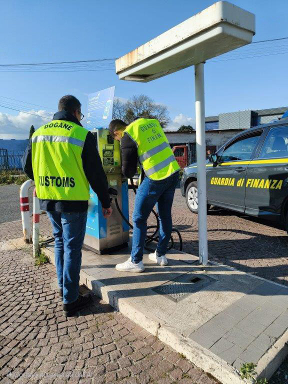 Due funzionari, uno della Guardia di Finanza e uno delle Dogane, controllano un distributore di carburante.