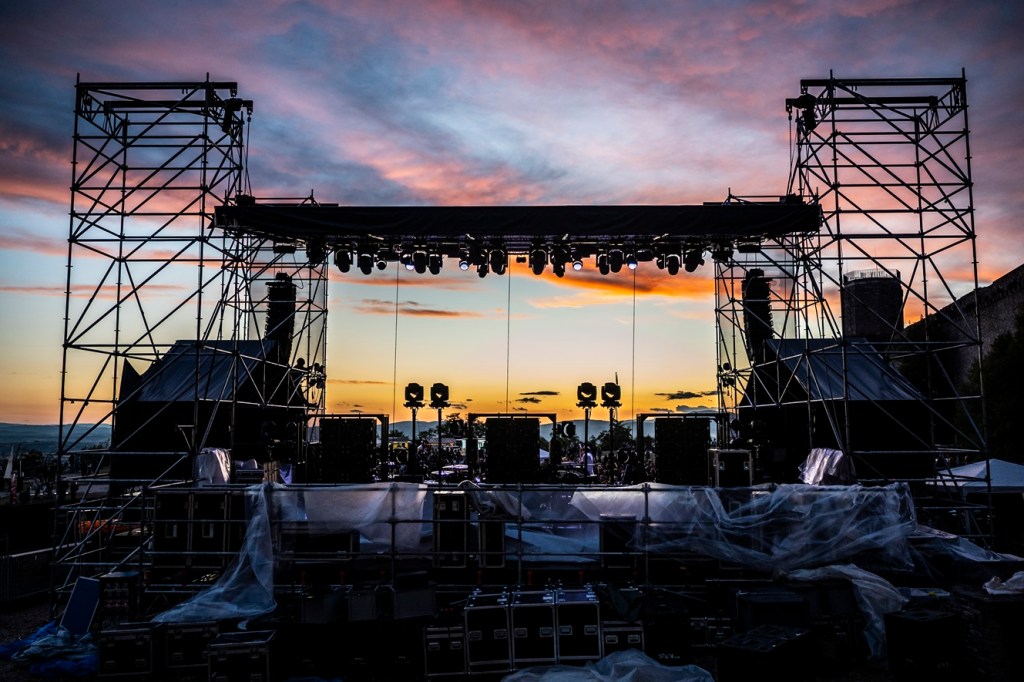 Struttura del palco allestito per il concerto al festival Suoni Controvento, con un suggestivo tramonto nel cielo.