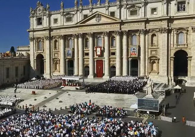 Large crowd gathered in front of St. Peter's Basilica in Vatican City during a formal event or ceremony.
