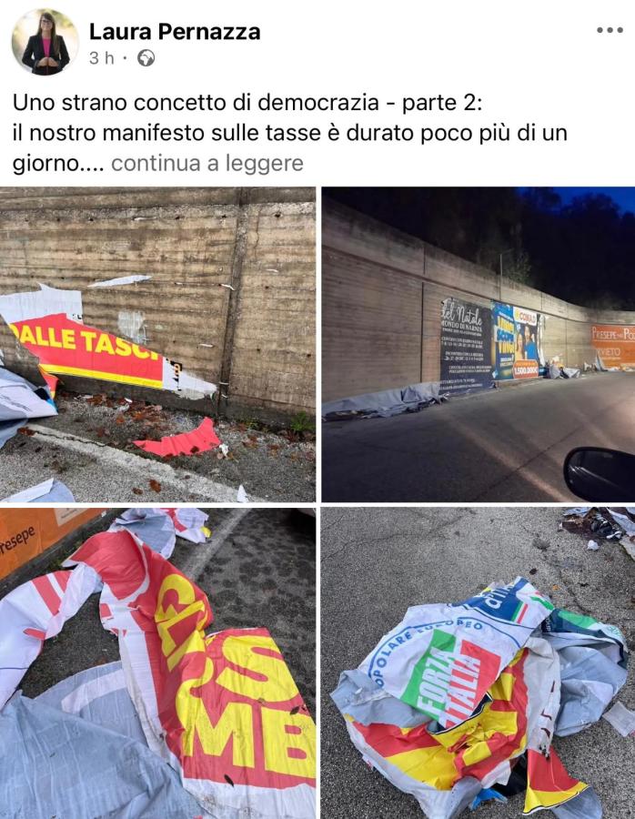 Close-up view of torn and discarded banners on a roadside, featuring various colors and texts, depicting a scene of neglect and disarray.